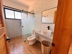 a bathroom with a toilet and a sink at BOSK TAPALPA - Cabaña en Tapalpa in Tapalpa