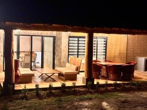 a patio with a table and a couch and chairs at BOSK TAPALPA - Cabaña en Tapalpa in Tapalpa +39 photos