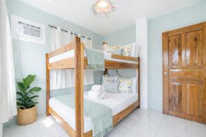 a bedroom with a bunk bed and a door at Bijunas Homestay in General Luna