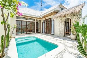 a swimming pool in the backyard of a house at Villa Wedas in Canggu