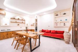 a living room with a red couch and a table at Villa Wedas in Canggu