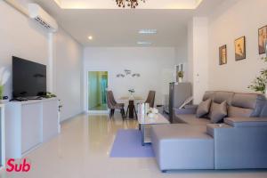 a living room with a couch and a table at Dream Home in Hat Yai in Ban Kohong