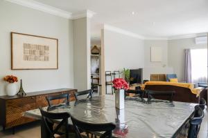 a dining room with a table and chairs at Nest - The Homestead in Howick