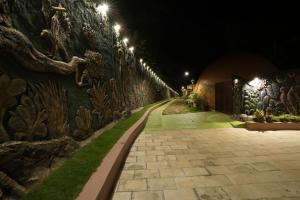 a stone wall with lights on it at night at Lake Lagoon Moonhills in Mennānyam