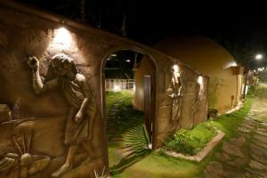 a statue on the side of a building at night at Lake Lagoon Moonhills in Mennānyam