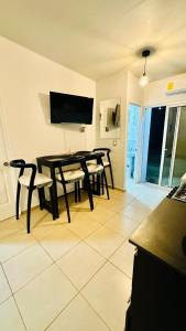 a dining room with a black table and chairs at Casa de Sasha in El Matazano