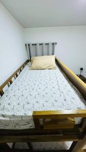 a bed in a room with a wooden frame at Casa de Sasha in El Matazano