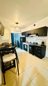a large kitchen with a table and a counter top at Casa de Sasha in El Matazano