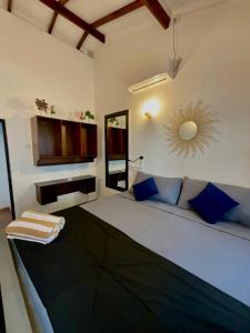 a bedroom with a large bed with a mirror on the wall at Hiricurry,Rooms Hostel & Restaurant in Dickwella