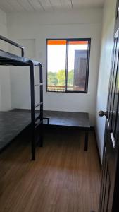 a room with a bunk bed and a window at The Cozy Nook - Dorm in Batangas City