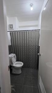 a bathroom with a toilet and a shower at The Cozy Nook - Dorm in Batangas City