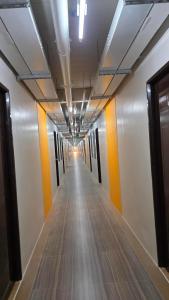 a hallway with orange and white walls and a long corridor at The Cozy Nook - Dorm in Batangas City