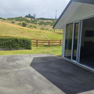 a house with a driveway next to a fence at Seventy-Four on Ramsay in Taupo +3 photos