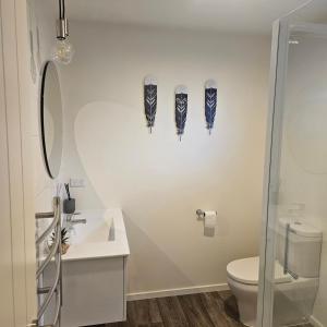 a bathroom with a toilet and a sink at Seventy-Four on Ramsay in Taupo