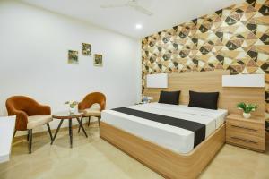 a bedroom with a bed and a table and chairs at Heritage Villa in Ludhiana