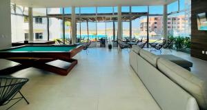 a living room with a pool table in a building at Bluu lagoons in Los Cerritos