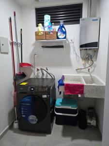 a kitchen with a washing machine and a sink at Bluu lagoons in Los Cerritos +11 photos
