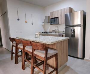 a kitchen with a counter and a refrigerator at Bluu lagoons in Los Cerritos