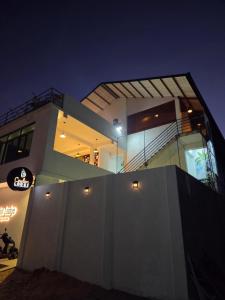 a large building with a night view of it at Ceylon Lodge - Airport Transit Hostel in Negombo