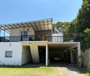 a house with a balcony on top of it at V&V House in Concordia