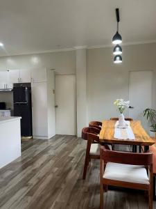 a living room with a dining room table and a kitchen at Sondela Cabin Lambug 3BR exclusive Villa in Badian