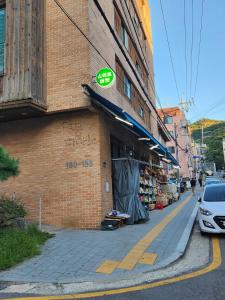 a store with a sign on the side of a brick building at Finetree House in Samgong