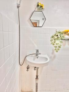 a bathroom with a sink and a mirror on the wall at Finetree House in Samgong