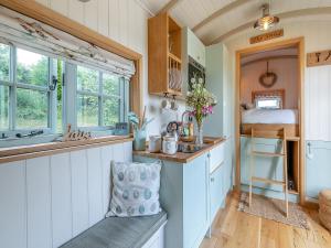 a kitchen with a sink and a bed in a room at Herbie's Shepherd Hut - Uk50229 in Nottingham