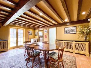 a dining room with a wooden table and chairs at Oaklands Farm - Cottage 5 in Broughton