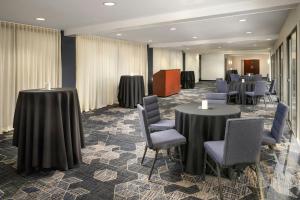 a conference room with two tables and chairs and tablesktop at Courtyard Hartford Cromwell in Cromwell +65 photos