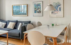 a living room with a table and a couch at 3 Bedroom Beautiful Home In Simrishamn in Simrishamn