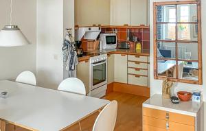 a kitchen with a stove top oven next to a window at 3 Bedroom Beautiful Home In Simrishamn in Simrishamn