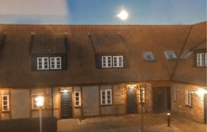 a large brick building with a moon in the sky at 3 Bedroom Beautiful Home In Simrishamn in Simrishamn