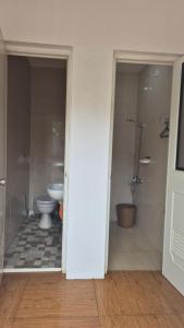 an empty bathroom with a toilet and a shower at M Residence Capsule Rooms in San Francisco