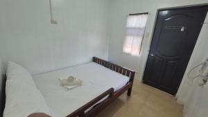 a small bedroom with a bed with a hat on it at M Residence Capsule Rooms in San Francisco