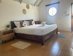 a bedroom with a bed with two teddy bears on it at Chamin Longbeach Bungalow in Ko Lanta