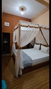 a bedroom with a bed with a canopy at SumateraTrekingOrangutanPatrol in Bukit Lawang