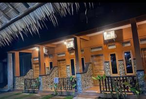 a building with a fence in front of it at SumateraTrekingOrangutanPatrol in Bukit Lawang