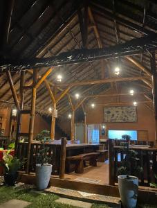 a large room with wooden beams and a large table at SumateraTrekingOrangutanPatrol in Bukit Lawang