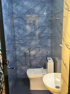 a bathroom with a shower and a toilet and a sink at SBJ Road House in Varkala