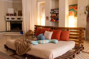 a bed with a teddy bear laying on top of it at Colibring nomads in Tbilisi City +41 photos