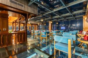 a restaurant with blue chairs and tables at Aarya Hotel and Spa - Eternal Heritage in Kathmandu