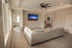 a living room with a couch and a ceiling fan at The Mustang Collection 49 in Page