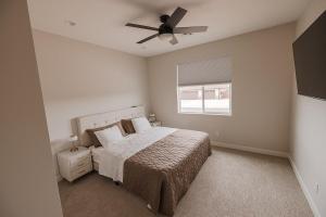 a bedroom with a bed and a ceiling fan at The Mustang Collection 49 in Page