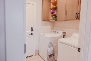 a small white laundry room with a washer and dryer at The Mustang Collection 49 in Page +29 photos