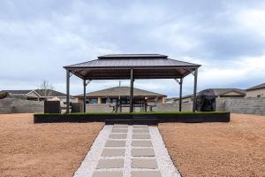 a gazebo with a picnic table in a field at The Mustang Collection 49 in Page