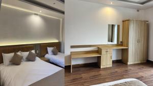 a bedroom with a bed and a desk with a mirror at The Staycation Pokhara in Pokhara
