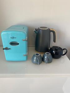 a toaster and two pots and pans on a counter at The Elephants Nest in Victor Harbor