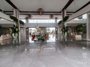 a lobby with plants and couches in a building at Prime World District Condo in Pajak