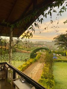 a view from the balcony of a house with a bridge at Whispering Hills in Nuwara Eliya